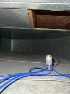 Air duct cleaning brush removing dust and debris from inside a vent.