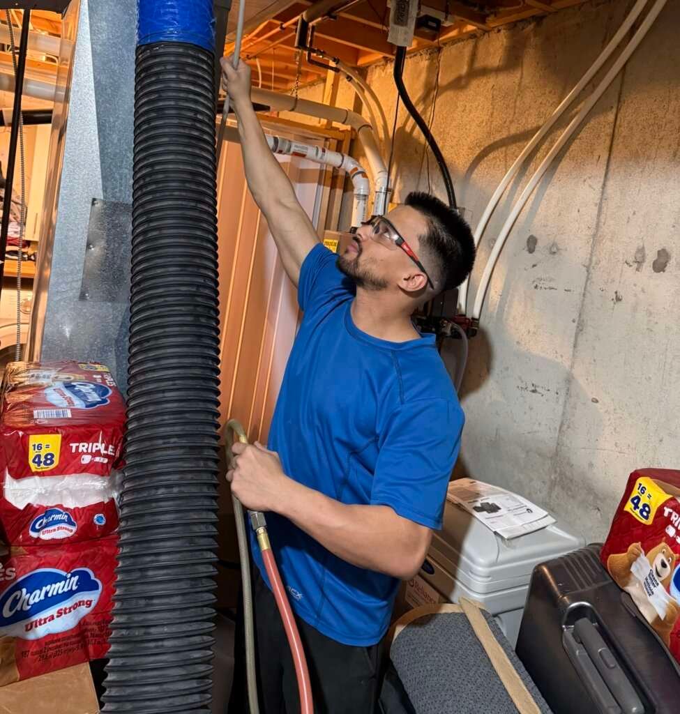 Technician Cleaning Ducts in action.